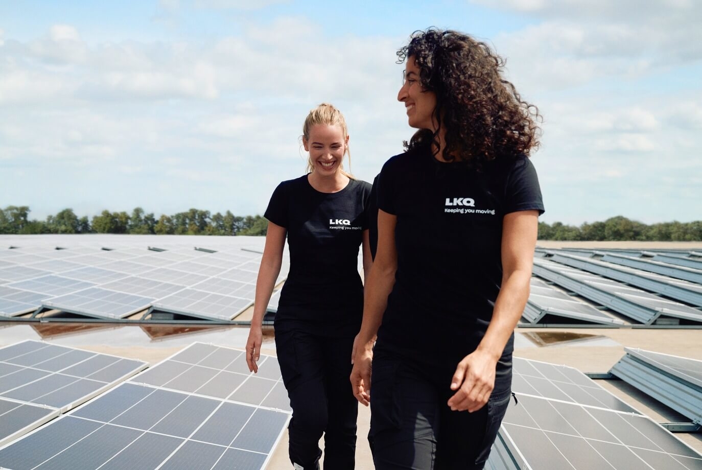 LKQ employees walk through solar panels